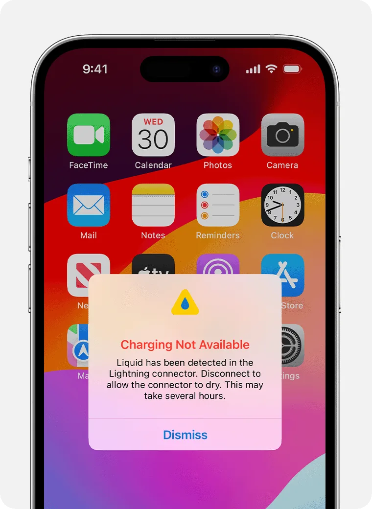 Alert on the iPhone: Charging Not Available, liquid has been detected in the connector, with the Dismiss button.
